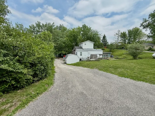 a view of a chair and table in the garden