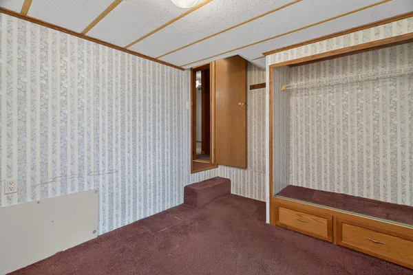 a view of a livingroom with furniture and staircase