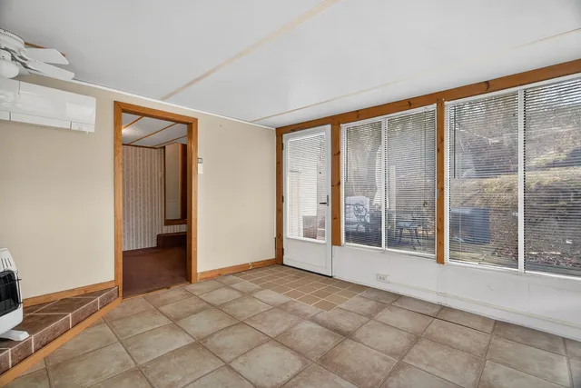 an empty room with windows and closet