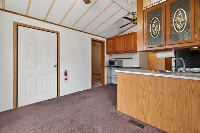 a view of a kitchen with stainless steel appliances granite countertop cabinets and a refrigerator