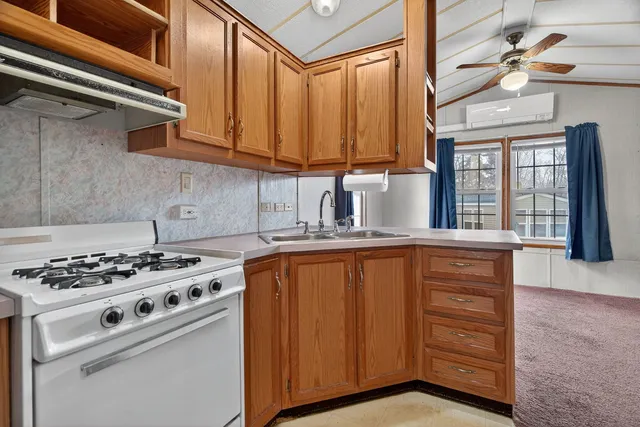a kitchen with stainless steel appliances granite countertop a stove a sink and dishwasher