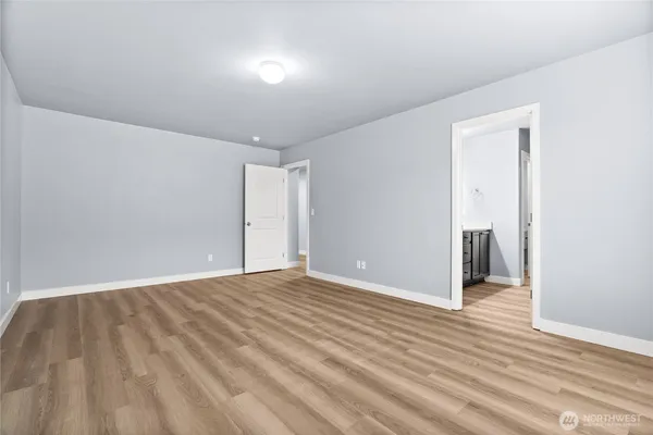 a view of an empty room and wooden floor