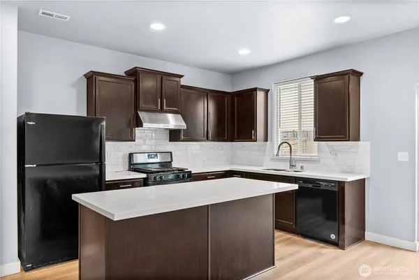 a kitchen with a sink and refrigerator