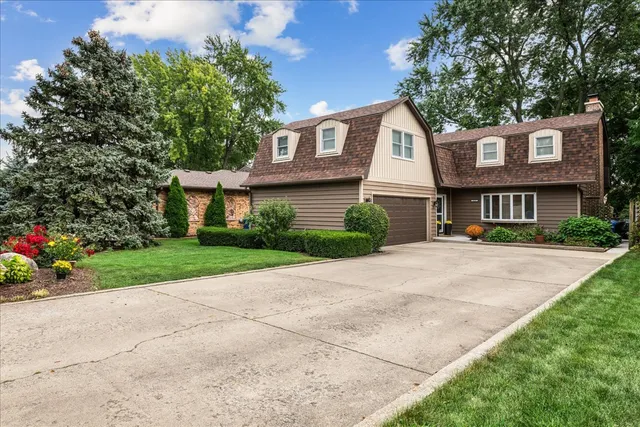 a front view of a house with a yard and a garage