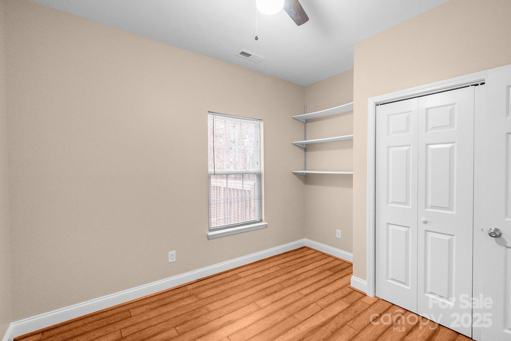 3687 East North Corner Road Lancaster, SC 29720 - Photo 17 of 47 a view of empty room with wooden floor and fan