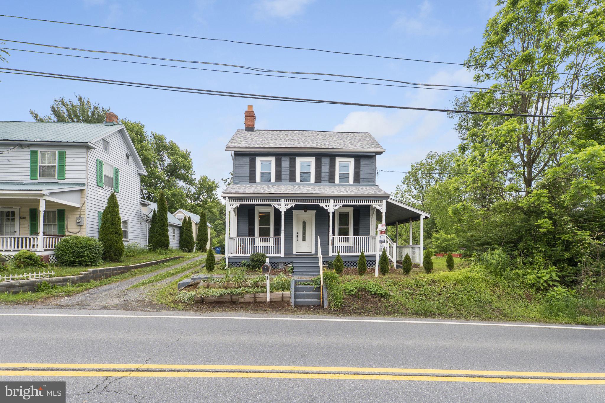 26001 Frederick Road Clarksburg, MD 20871 - Photo 46 of 46 a front view of a house with a garden