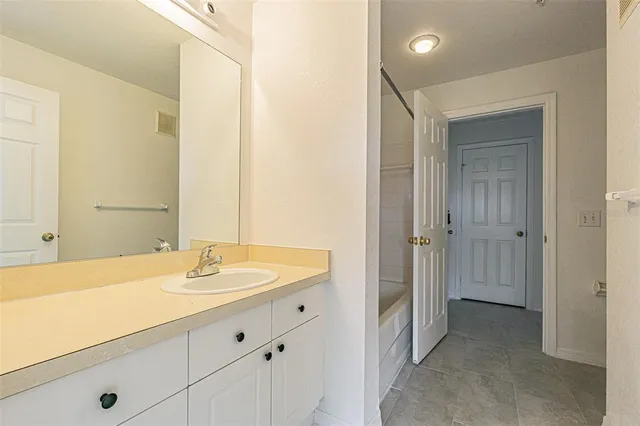 a kitchen with stainless steel appliances granite countertop a sink stove and white cabinets