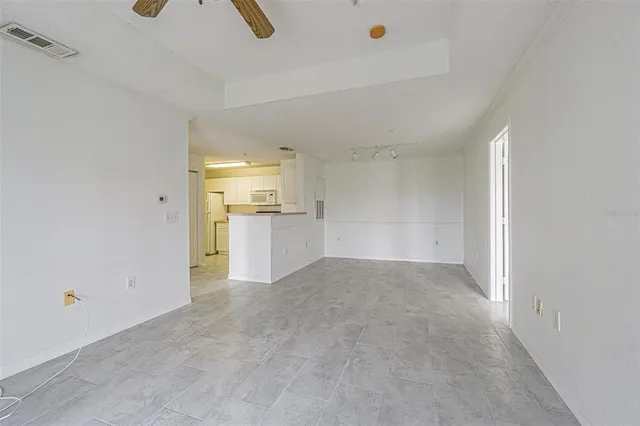 a view of a kitchen with a refrigerator and a sink