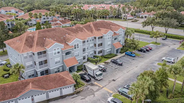 an aerial view of a house with a garden and lake view