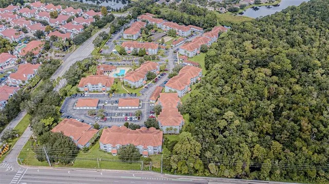 an aerial view of a house with a yard