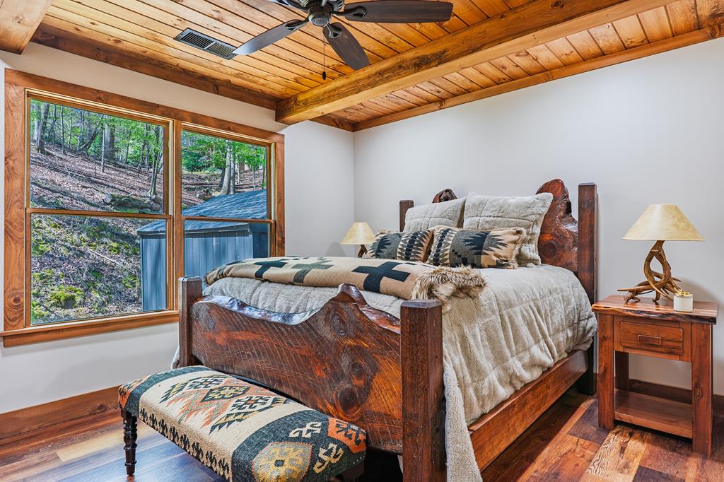 480 Riveredge Lane Ellijay, GA 30540 - Photo 25 of 66 a bedroom with a bed and wooden floor