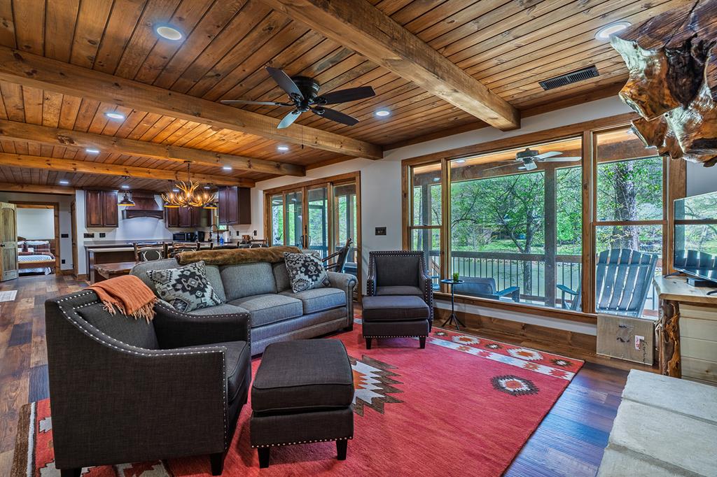 480 Riveredge Lane Ellijay, GA 30540 - Photo 29 of 66 a living room with furniture a wooden floor and a potted plant
