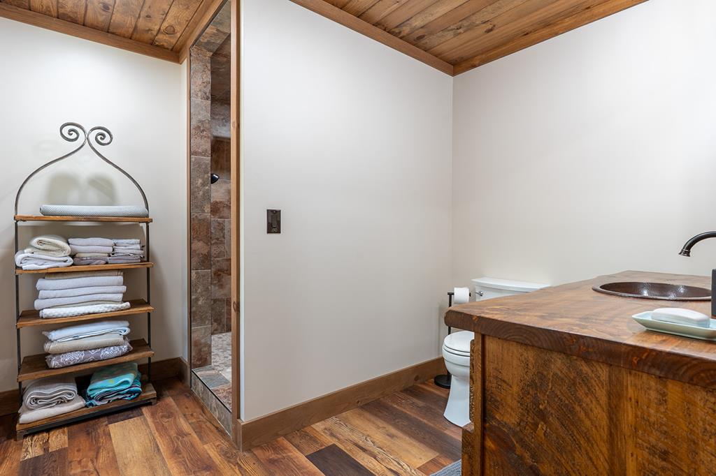 480 Riveredge Lane Ellijay, GA 30540 - Photo 36 of 66 a room that has a bed and a wooden floor