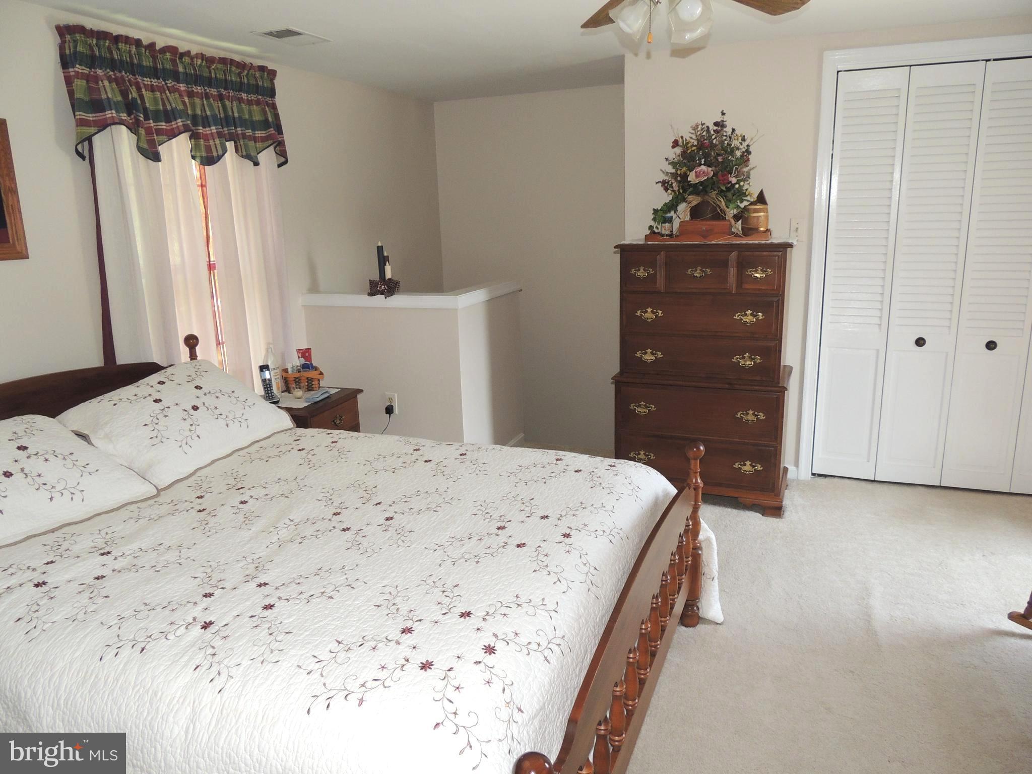 13730 Unionville Road Mount Airy, MD 21771 - Photo 13 of 30 a bedroom with a bed and a dresser