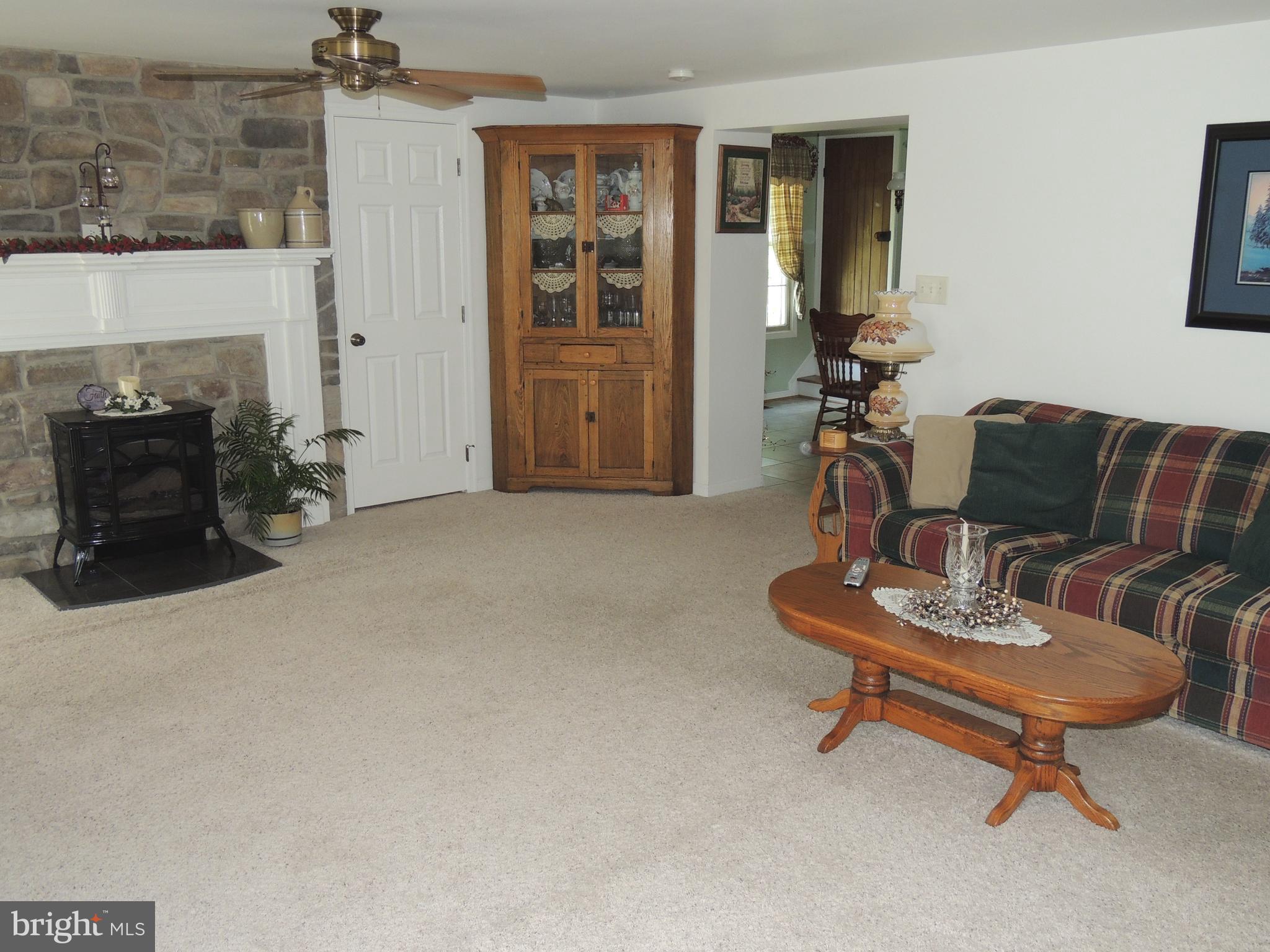 13730 Unionville Road Mount Airy, MD 21771 - Photo 3 of 30 a living room with furniture and a fireplace