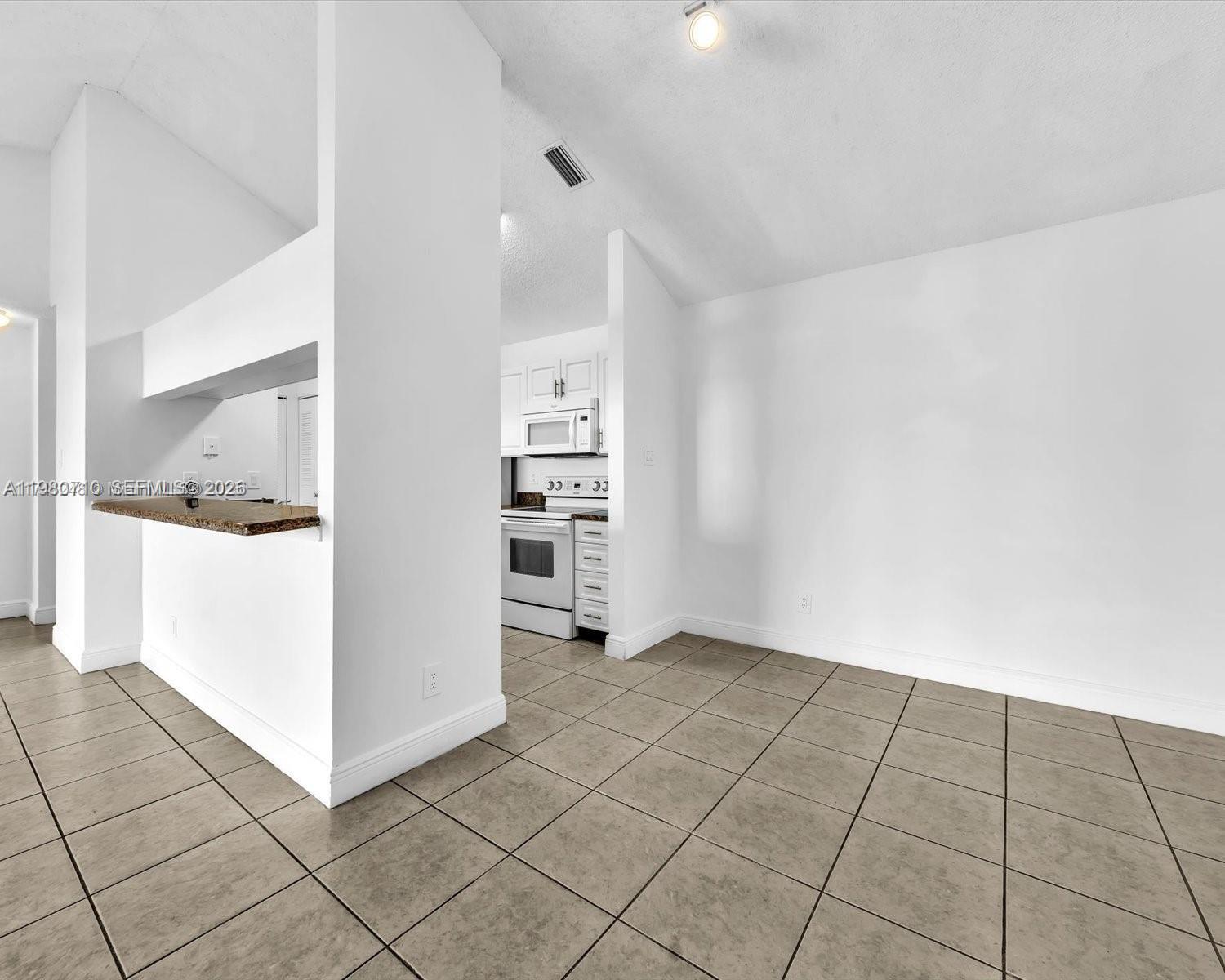15770 Southwest 106th Terrace, Unit 303 Miami, FL 33196 - Photo 12 of 64 a view of an empty room