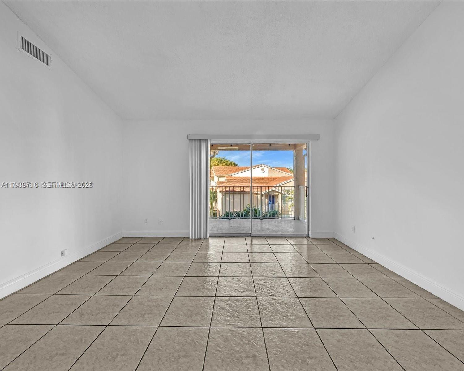 15770 Southwest 106th Terrace, Unit 303 Miami, FL 33196 - Photo 15 of 64 a view of an empty room and window