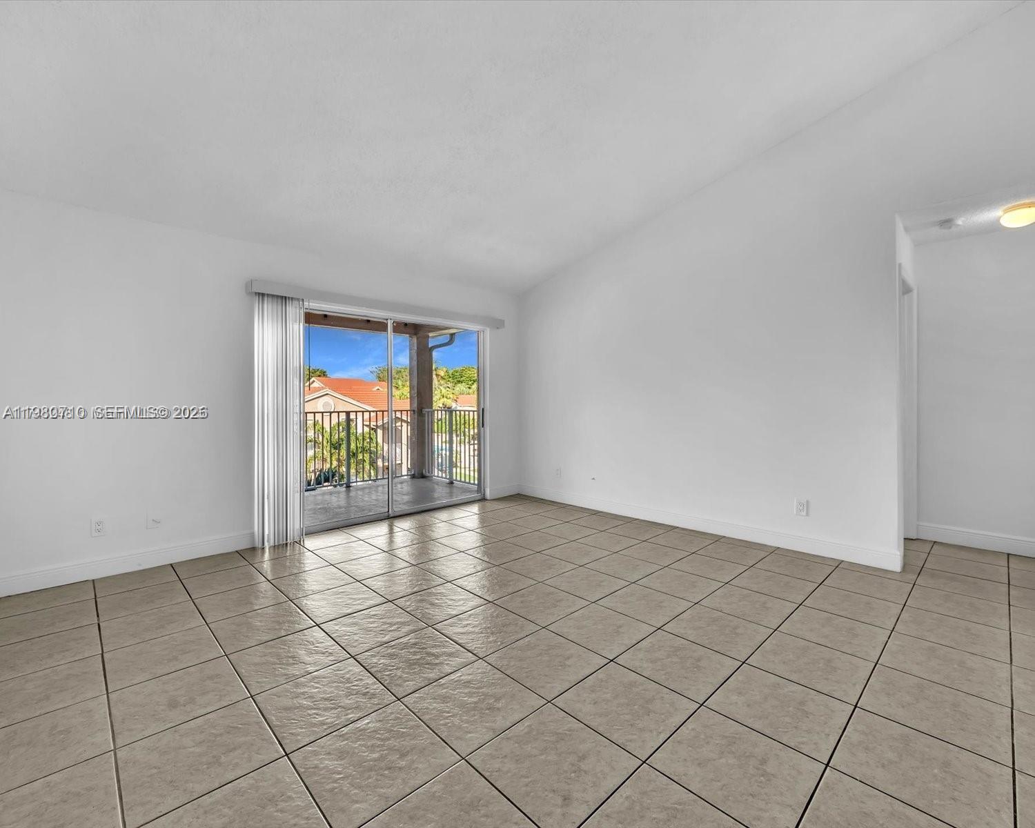 15770 Southwest 106th Terrace, Unit 303 Miami, FL 33196 - Photo 16 of 64 a view of an empty room and window