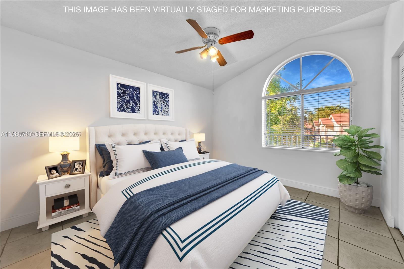 15770 Southwest 106th Terrace, Unit 303 Miami, FL 33196 - Photo 22 of 64 a bedroom with bed and a window