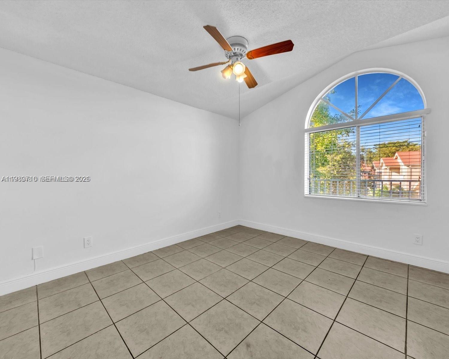 15770 Southwest 106th Terrace, Unit 303 Miami, FL 33196 - Photo 23 of 64 an empty room with windows and ceiling fan