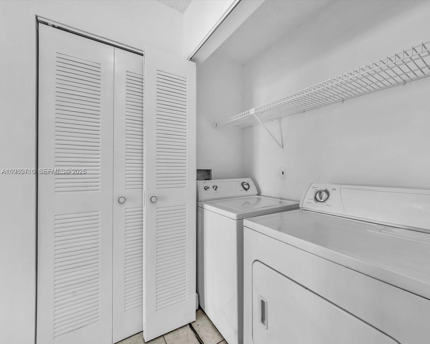 15770 Southwest 106th Terrace, Unit 303 Miami, FL 33196 - Photo 29 of 64 a utility room with dryer and washer