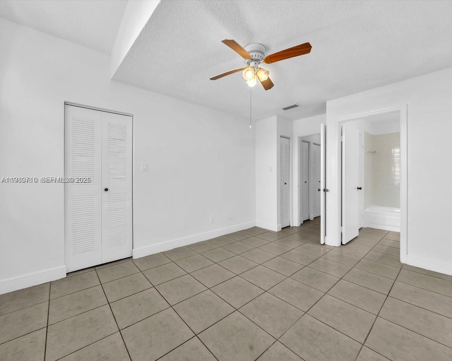15770 Southwest 106th Terrace, Unit 303 Miami, FL 33196 - Photo 31 of 64 an empty room with closet and fan