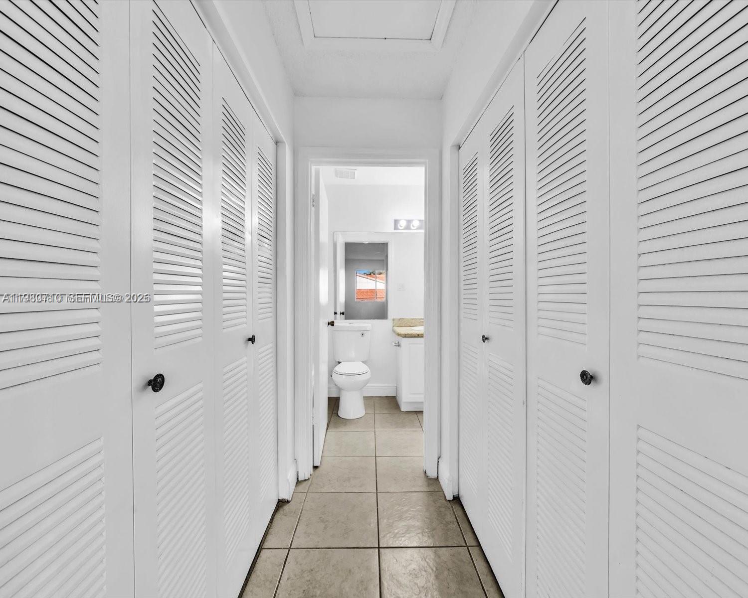 15770 Southwest 106th Terrace, Unit 303 Miami, FL 33196 - Photo 35 of 64 a view of a bathroom from the hallway