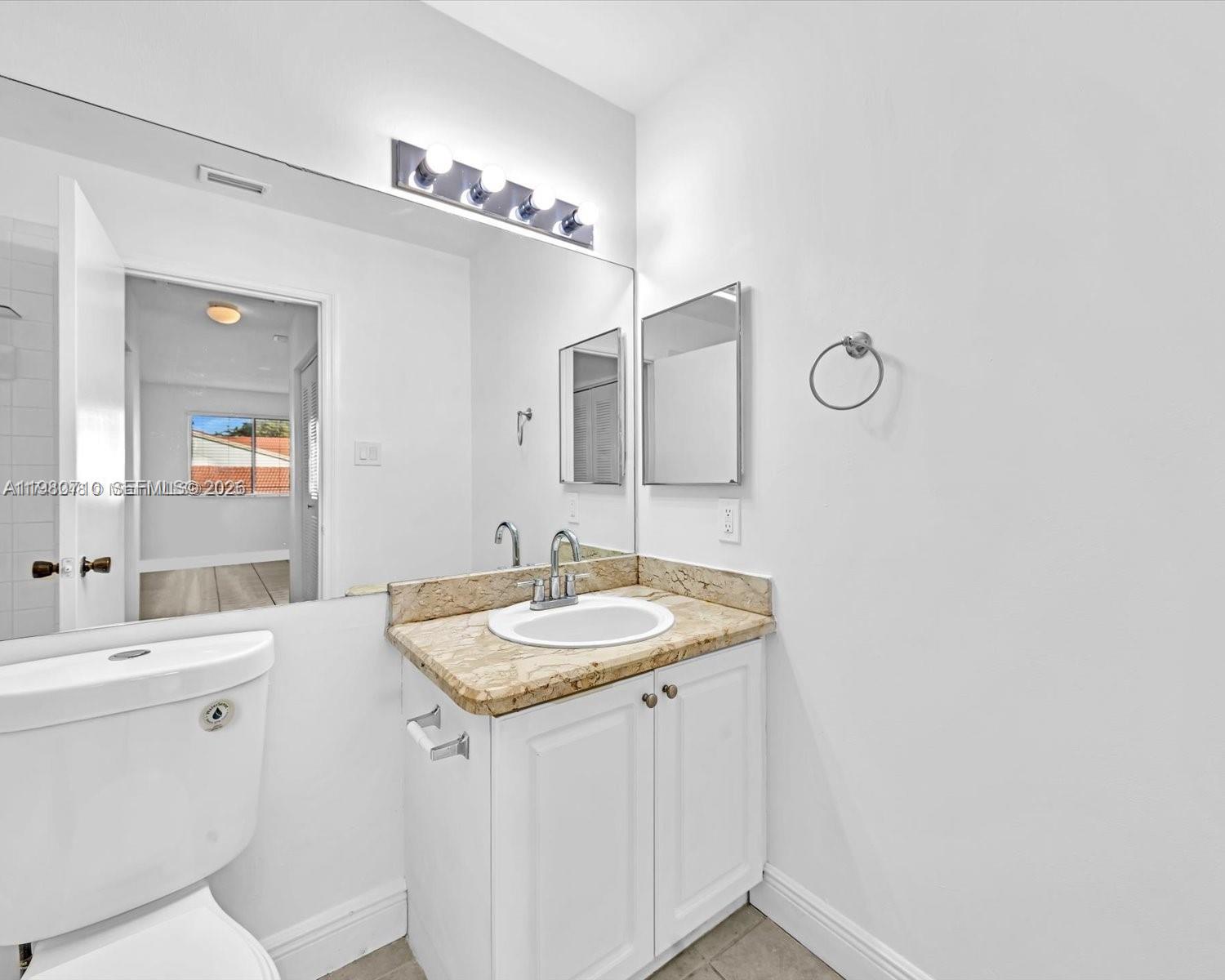 15770 Southwest 106th Terrace, Unit 303 Miami, FL 33196 - Photo 40 of 64 a bathroom with a sink and a mirror