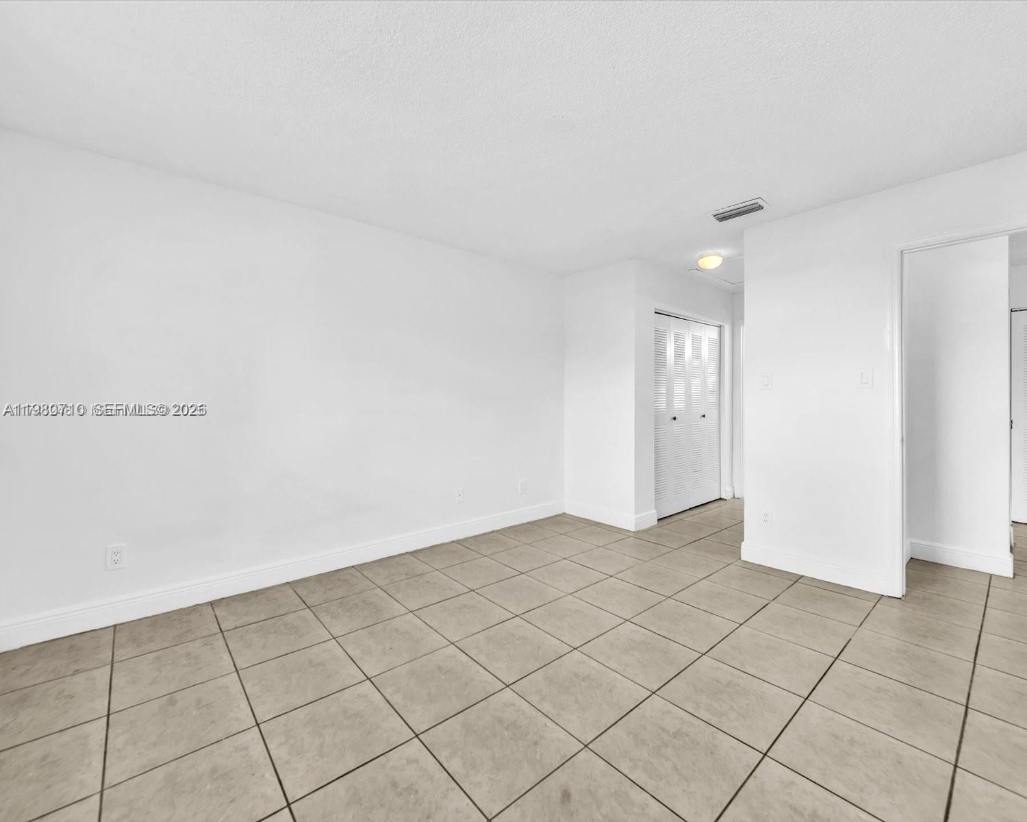 15770 Southwest 106th Terrace, Unit 303 Miami, FL 33196 - Photo 41 of 64 a view of an empty room and window