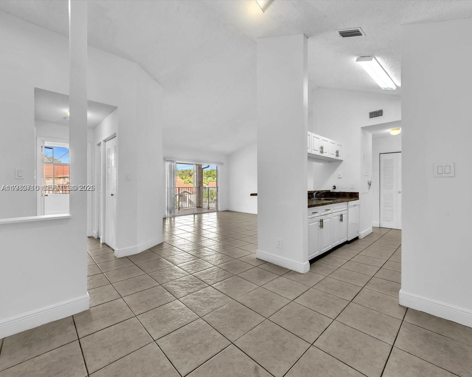 15770 Southwest 106th Terrace, Unit 303 Miami, FL 33196 - Photo 46 of 64 a view of kitchen with granite countertop appliances cabinets and a counter top space