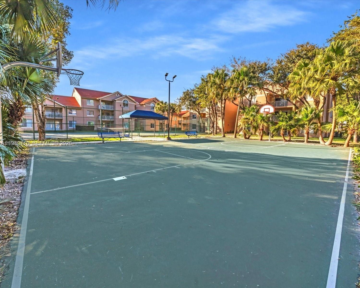 15770 Southwest 106th Terrace, Unit 303 Miami, FL 33196 - Photo 49 of 64 a view of a tennis ground with large trees