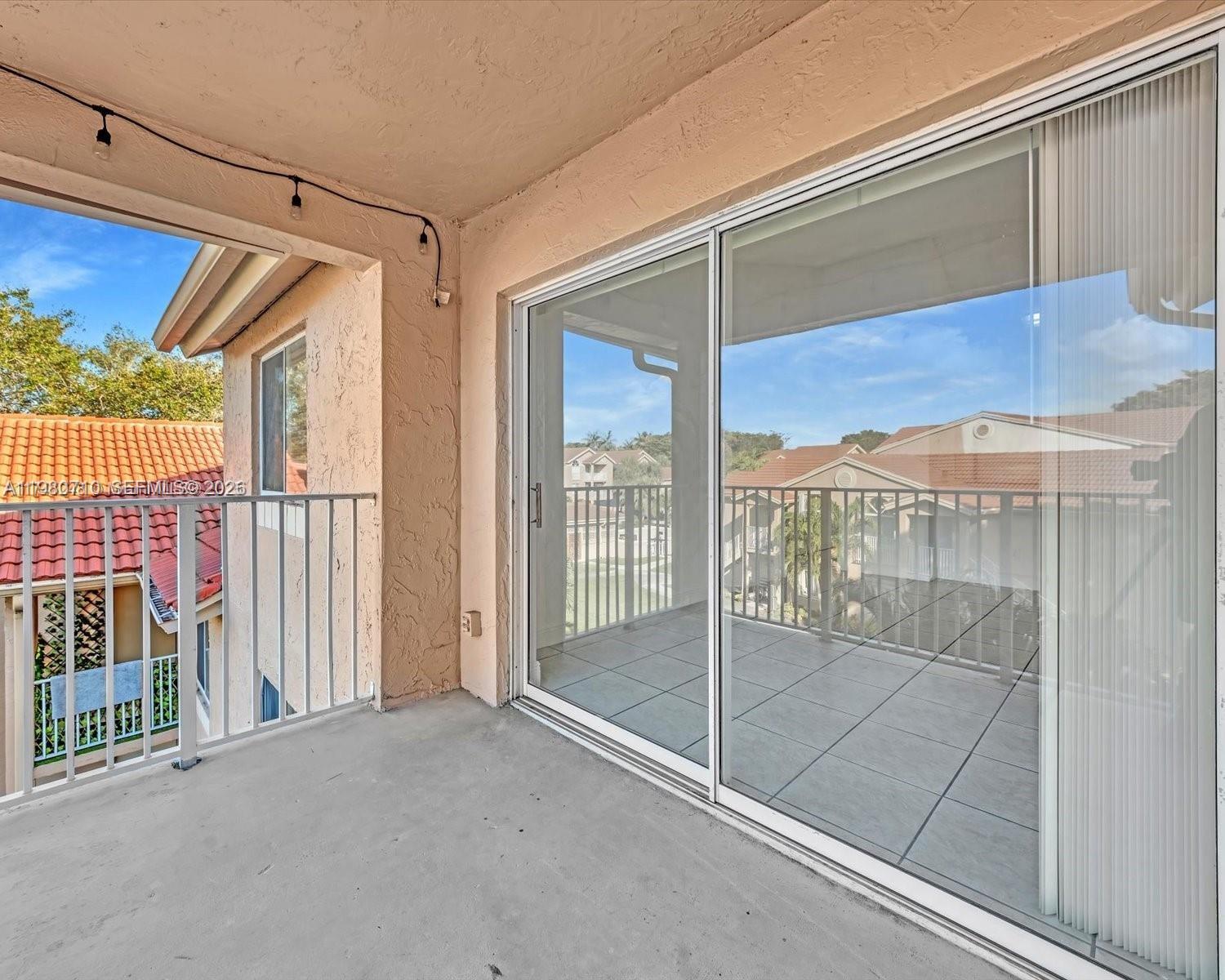 15770 Southwest 106th Terrace, Unit 303 Miami, FL 33196 - Photo 60 of 64 a view of a glass door and the porch