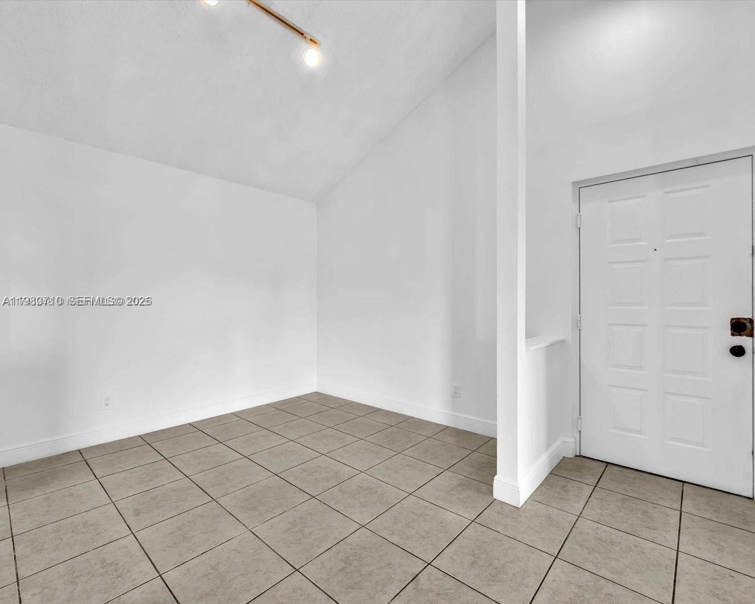 15770 Southwest 106th Terrace, Unit 303 Miami, FL 33196 - Photo 6 of 64 an empty room with white walls