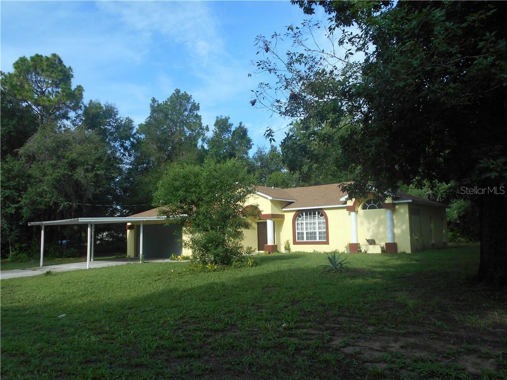13309 Canyon Swallow Road Weeki Wachee, FL 34614 - Photo 1 of 1 a front view of a house with a yard