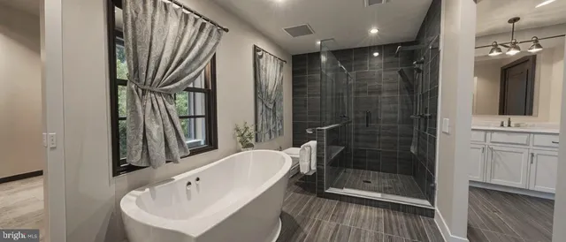a bathroom with a bathtub and a shower