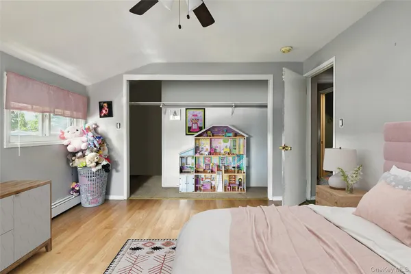 a bedroom with a bed and a large mirror