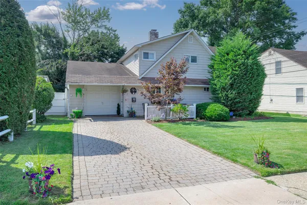 a front view of a house with a garden