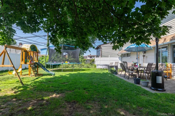 a view of a backyard with a table and chairs