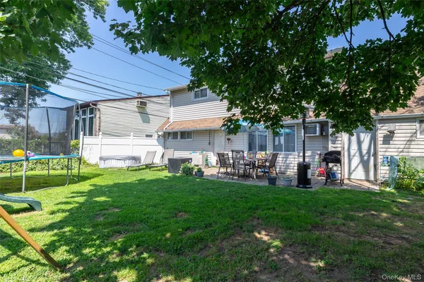 a view of a house with a yard and sitting area
