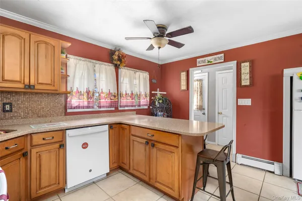 a kitchen with cabinets appliances and a window