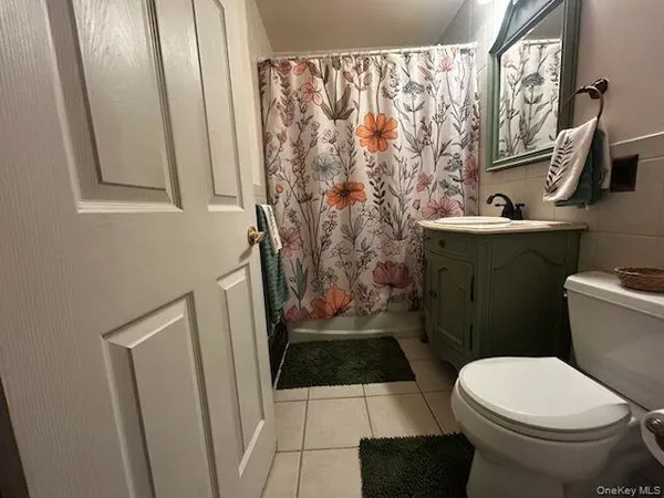 a bathroom with a toilet and a shower curtain