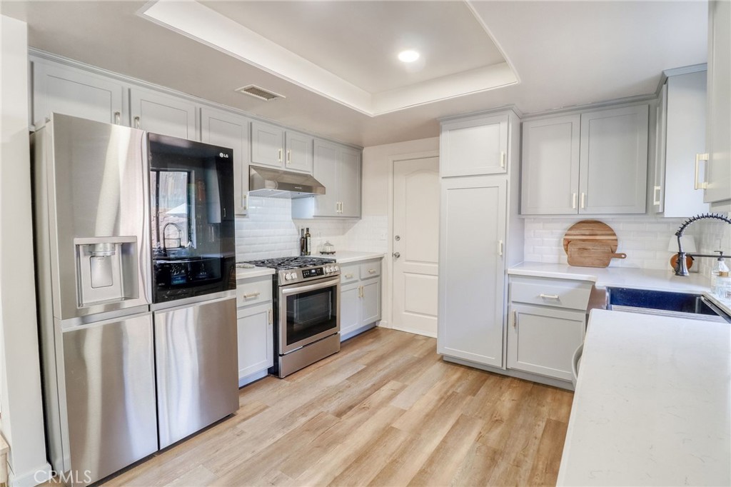 14235 Judy Ann Drive Riverside, CA 92503 - Photo 15 of 68 a kitchen with stainless steel appliances a refrigerator stove and sink
