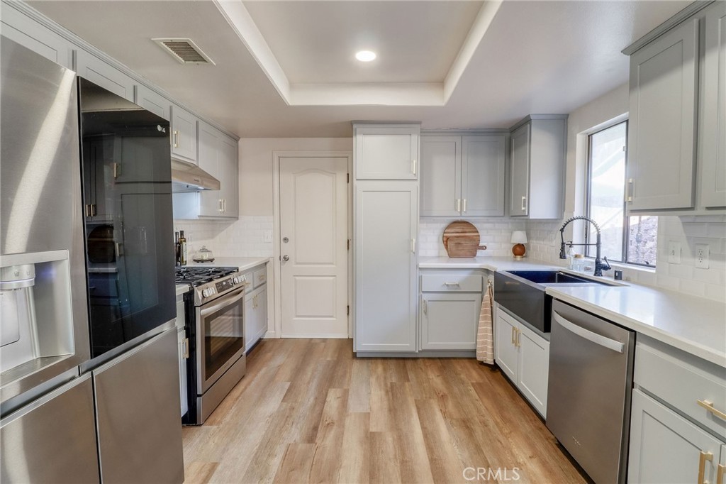 14235 Judy Ann Drive Riverside, CA 92503 - Photo 18 of 68 a kitchen with a sink stove and refrigerator