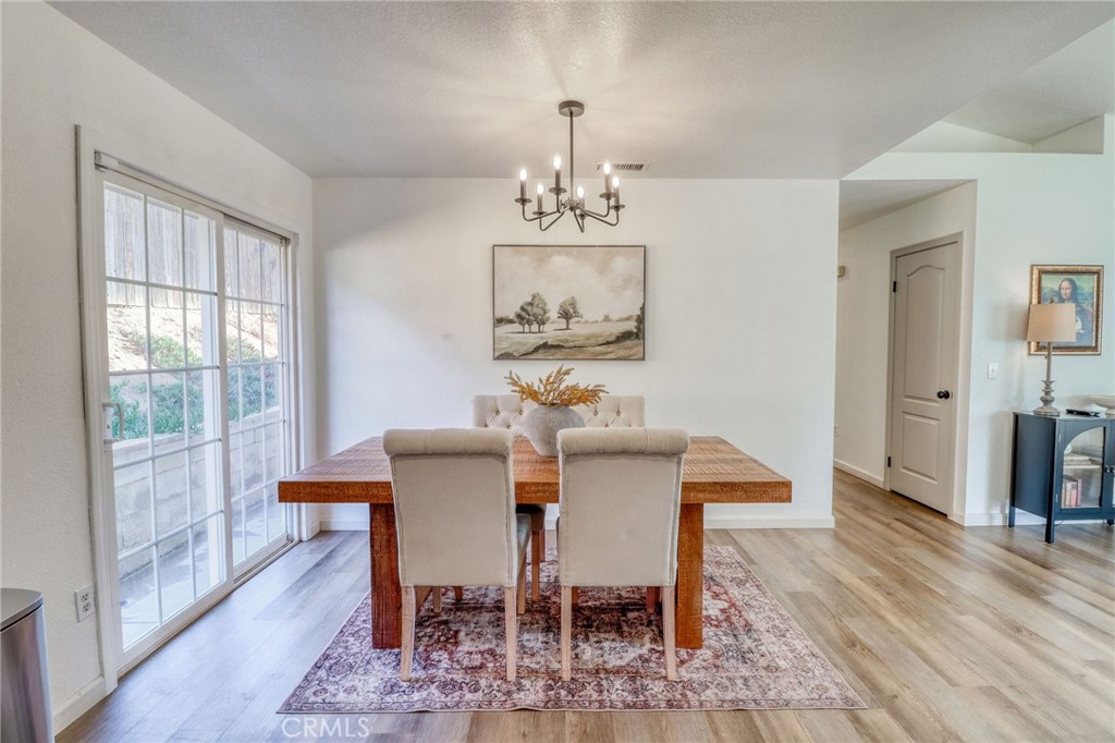14235 Judy Ann Drive Riverside, CA 92503 - Photo 21 of 68 a view of a dining room with furniture window and wooden floor