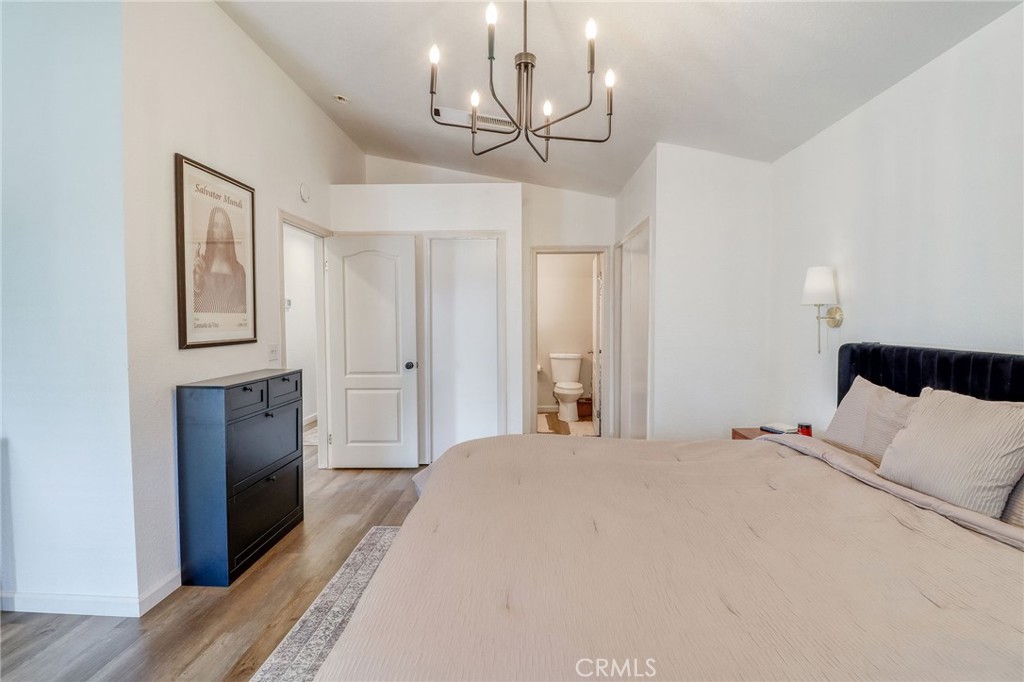 14235 Judy Ann Drive Riverside, CA 92503 - Photo 27 of 68 a bedroom with a bed and a chandelier