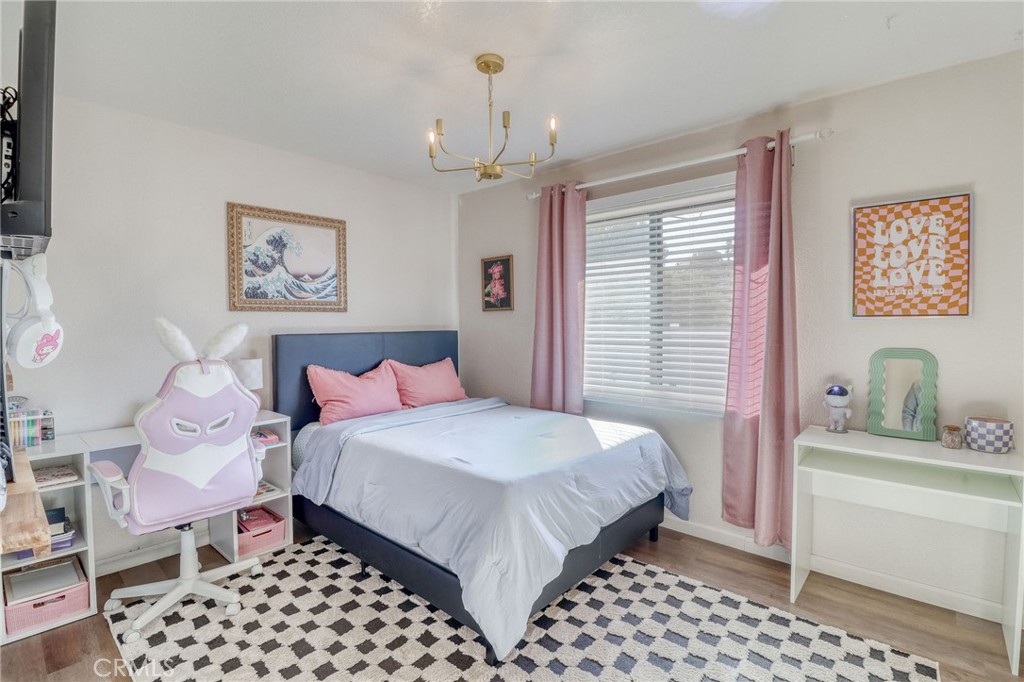 14235 Judy Ann Drive Riverside, CA 92503 - Photo 35 of 68 a bedroom with a bed and dresser with mirror