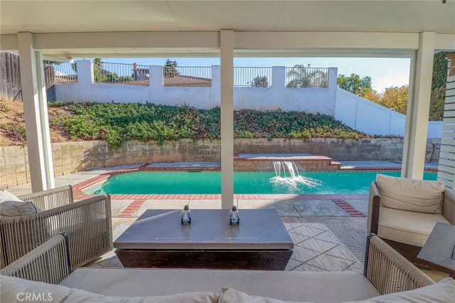 an aerial view of a house with a yard and a large tree