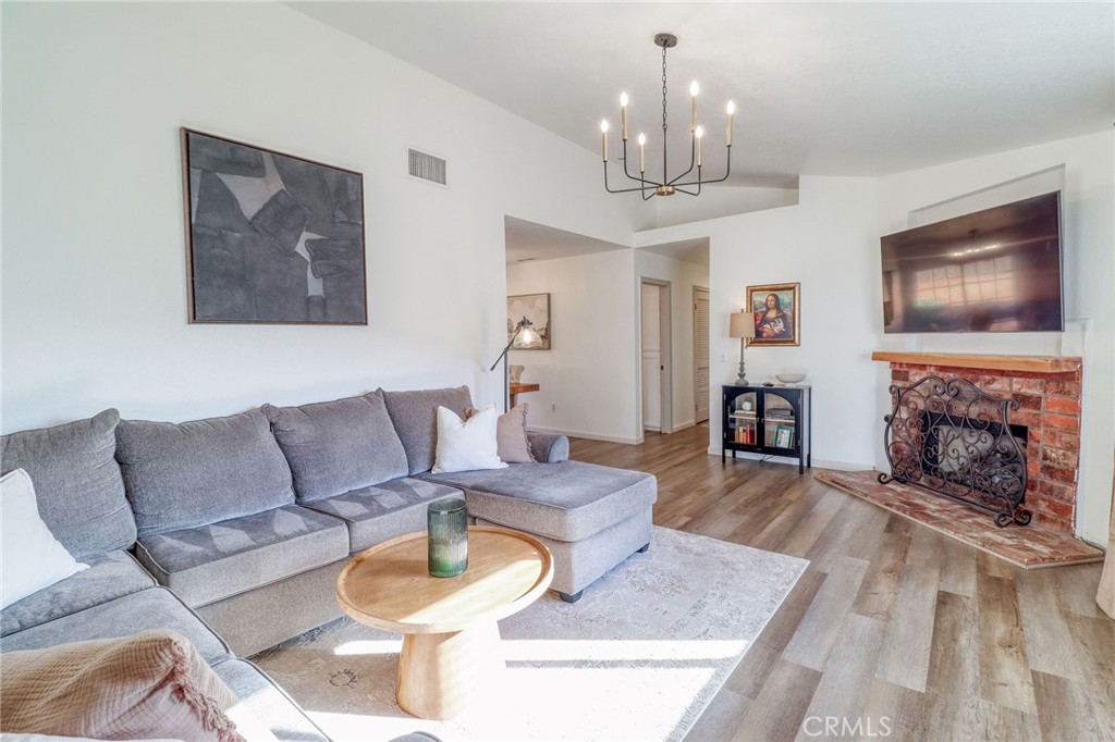 14235 Judy Ann Drive Riverside, CA 92503 - Photo 8 of 68 a living room with furniture a fireplace and a chandelier