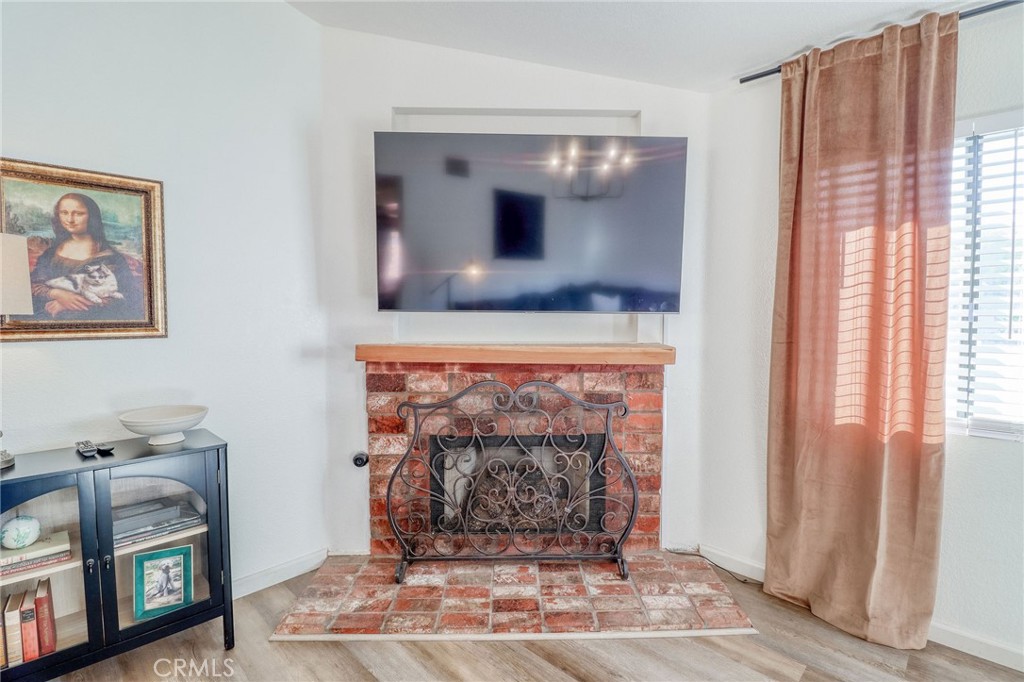 14235 Judy Ann Drive Riverside, CA 92503 - Photo 10 of 68 a living room with a fireplace and a flat screen tv