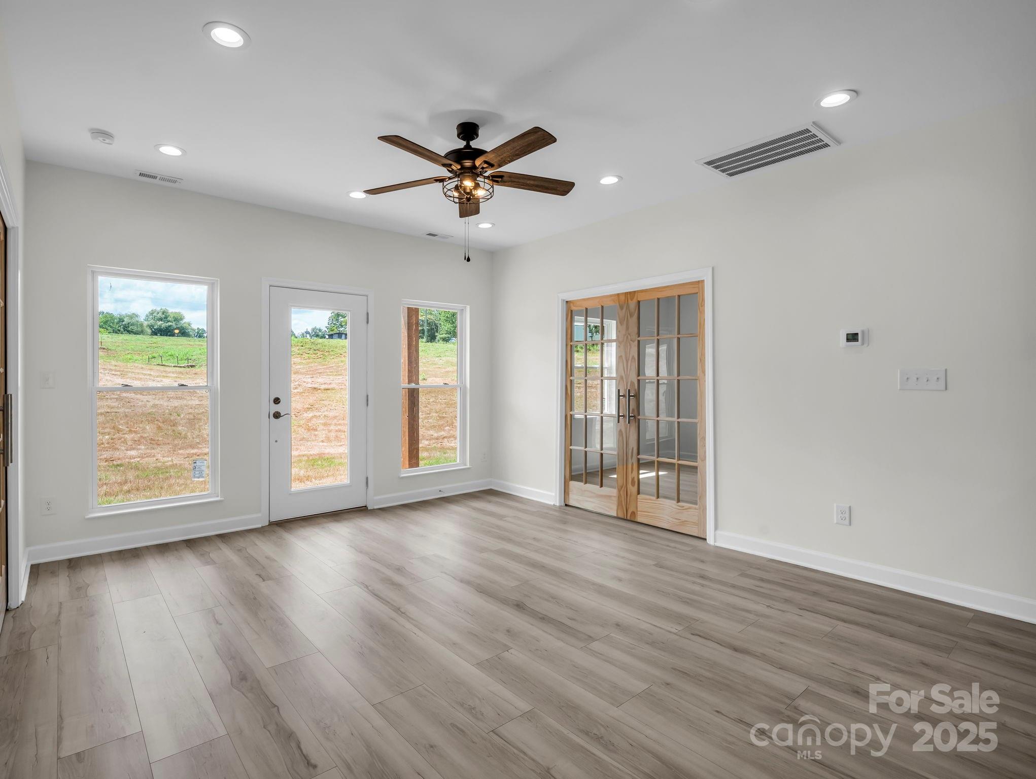 174 Charlie Randall Road Lawndale, NC 28090 - Photo 16 of 41 a view of an empty room with a window and wooden floor